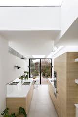 Mirrors, rooflights, clerestory glazing, and changes of ceiling level create a sense of spaciousness that defies the actual dimensions of the extension.