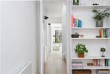 Full-height doors enable circulation to appear as part of open-plan spaces when open, while rooflights and clerestory windows in the corners of the extension visually break down the sense of enclosure of the building envelope.