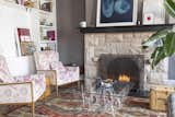 A fireplace anchors the couple's living room, which is adorned with modern artwork as well as beloved curios.