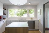 Kitchen, Dishwasher, White Cabinet, Medium Hardwood Floor, Recessed Lighting, Pendant Lighting, and Ceiling Lighting  Photos from Bridge House