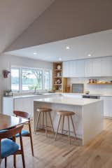 Kitchen, Light Hardwood Floor, White Cabinet, and Recessed Lighting Kitchen island.  Photo 13 of 21 in Gallery Residence by FORWARD Design | Architecture
