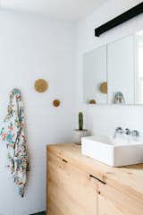 Knobs or hooks are a better choice than towel bars for tight space or unruly bathroom mates.  Photo 1 of 2 in It's a Simple Life by Suburban Modern