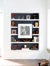 Run out of wall for your new art splurge?  Nothing wrong with using the bookcase taking up one wall.  In fact, the art serves as focus to draw the eye in.  Dark color back wall makes this work.