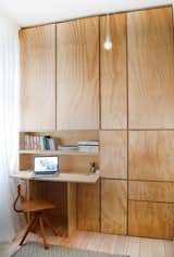 Super straight forward storage wall of plywood with no nonsense desk solution.  