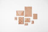 Suntan Pattern by  Nendo 
Nendo exploits leather's characteristics by using tanning oil or sunscreen to place an invisible pattern on the surface of the leather. 