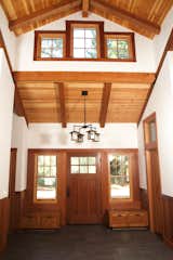 A home in Sonoma County, California uses redwood for the interior beams, trim, and entryway storage to evoke a pastoral warmth.