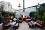 Diners who prefer to share a meal outdoors keep warm by the fireplace.  Joshua McCowen’s Saves from A Spanish Restaurant With an Industrial Infusion