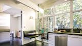 Booth seating in the eat-in kitchen creates a cozy nook behind a private bamboo fence.