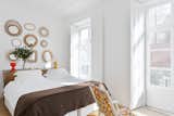 Bedroom, Bed, Lamps, Light Hardwood Floor, Dresser, Chair, and Table Lighting Campo Grande, a two-bedroom on the fourth floor, has a long balcony that curves around the corner of Rua dos Fanqueiros and Rua da Conceição.  Photo 7 of 11 in Baixa House Lets Travelers Be at Home in Lisbon
