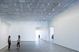 The exhibition spaces have polished concrete floors and custom aluminum mesh ceilings that are fitted with occupant-controlled LED lights. The museum is on course to be LEED-certified.