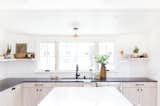 A white undermount sink and a matte black faucet are functional, refined elements.  Brittany Thielmann’s Saves from The Big Reveal: An Interior Designer Unveils Her “No Ordinary Kitchen” Makeover