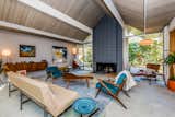The George Nelson Cigar and Saucer Pendant Lamps are original, and also available for purchase. A cinderblock fireplace provides an inviting focal point.  Photo 5 of 13 in With Only One Previous Set of Owners, a Pristine Eichler Home Asks $799K