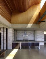 The light scoop illuminates a ceiling of sinuous plywood slats.  Photo 8 of 20 in Kitchen by LS from An Internationally Celebrated Home in the Australian Backcountry Asks $9M