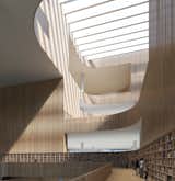 The wooden slats that line the central atrium are of varying transparency:  Photo 5 of 8 in Schmidt Hammer Lassen Architects’ Winning Design For the Shanghai Library