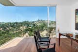 The guest bedroom, shown here as an office, offers an uninterrupted view of the surrounding canyon. "Walking into the space, it's just breathtaking," says JB Fung, agent and director of Aaroe Architectural.