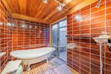 The freestanding tub in the master bath leads to a private, raised deck.