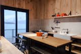 Kitchen and Wood Counter All the furniture in the home was created out of surplus building materials.  Photo 5 of 12 in kitchen ideas by MistyG from Just Getting to This Remote Patagonian Retreat Is an Adventure