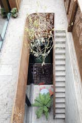 A sunken courtyard acts like a light well illuminating the basement, which is currently set up as a playroom, though it can be renovated to become additional bedrooms, an office, a self-contained studio, or even a lap pool.