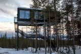 Guests ascend a staircase into the cabin, while a small lift carries up their luggage.  Photo 8 of 8 in Go Stargazing in Snøhetta’s Towering Addition to Sweden’s Treehotel