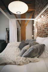 A George Nelson Saucer Lamp hangs over the bedroom.  Photo 10 of 10 in Step Inside One Couple’s Game-Changing Live/Work Loft