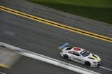 The image of a car appears on one side of the BMW Art Car #19, using two- and three-dimensional elements to add ambiguity to the work.  Photo 6 of 12 in John Baldessari Blazes a Trail at the Daytona International Speedway With BMW Art Car #19