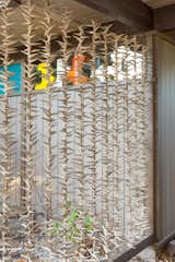 Strung seashells make up an organic screen for the carport, a natural touch added by the seller.