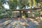 Set back from the street, the home provides privacy and seclusion. At the entrance, a carport leads to a brick-paved walkway that stretches to the front door.  Photo 2 of 11 in Snag This Midcentury Stunner in Southern California For $799K