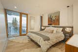 The master bedroom has access to a private terrace with alpine vistas.  Photo 7 of 10 in A Plunging Roof Carves Out Space in This Park City Home Offered at $2.4M