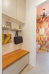 A clever storage area holds purses and bags, while a bench hides away bulkier items.  Photo 9 of 10 in A Plunging Roof Carves Out Space in This Park City Home Offered at $2.4M