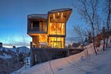 The shou sugi ban exterior siding stands as a bold contrast in the snow, and is