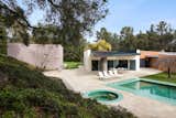 The pool and outdoor hot tub bounce green light off the roof hanging over the back terrace, creating a lush environment.  Photo 10 of 12 in IDEO Founder David Kelley Asks $13.5M for His Ettore Sottsass-Designed Masterpiece