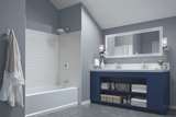 Bathroom with grey painted walls and an alcove tub and shower accented with white subway tiles.