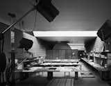 An archival photo shows the interior of the detached studio with drafting tables awash in light through the enormous skylight above.