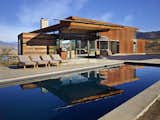Outdoor, Large Patio, Porch, Deck, Large Pools, Tubs, Shower, Concrete Patio, Porch, Deck, Concrete Pools, Tubs, Shower, and Desert In the summer months, the pool provides a welcome respite from the heat.  Photo 7 of 11 in A Steel-and-Glass Compound Is One Family’s Launchpad For Adventure