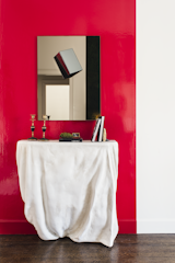 The white plaster Draper Console and modern Cube Mirror embody an unconventional spirit.