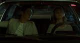 Jin and Casey have a conversation while parked in front of the First Financial Bank by Deborah Berke.