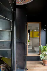 A raw steel spiral staircase leads to the roof terrace.