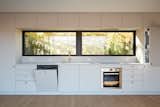 A full suite of Bosch appliances are seamlessly integrated into the kitchen. "We pride ourselves on innovations that serve people’s everyday needs,  Photo 2 of 5 in The Dwell House Kitchen May Be Compact, But It Packs a Punch