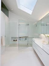 Located in Singapore, the 31 Blair Road house by ONG&ONG keeps it minimal without being stark or clinical. A floating cabinet holds two sinks and the large, rectangular shower is sealed with seamless glass panels, all under a slanted ceiling with a skylight.

Photo courtesy of ONG&ONG  Photo 7 of 8 in Bathrooms by Gonçalo Ferreira from 10 Minimalist Bathrooms of Our Dreams