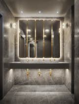 Porcelain tile, marble countertops, and brass trimmings give the in-room bathrooms a luxe feel.