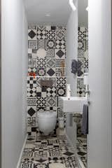 The small powder room features graphic ceramic tile from Couleurs & Matures Patchwork.

A Parisian Pied-À-Terre  by Piret Johanson Studio #designmilk