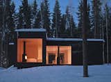 This carbon-neutral residence by Helsinki studio Avanto Architects features a facade clad in dark-stained wood and contrasting light-wood interiors. Located on an island in Finland, the cross-shaped cabin has no running water; the structure is solar-powered, well insulated, and warmed by multiple fireplaces.