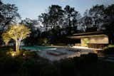 Landscape and a green wall provide an organic counterpoint to the Free Float Pool House's contemporary materials.