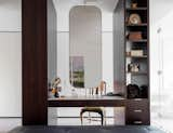 “Mirror mirror… who in this realm is the fairest of them all?” Jane McNeill’s masterful joinery is hard to beat with its dark American oak timber veneers, carara marble benchtop, polished chrome framed mirror, ottoman by Eileen Grey and frosted glass wall between the dressing room and ensuite bathroom to provide defused natural light for this otherwise landlocked space.
© Justin Alexander