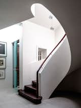 Spiral staircases have a unique characteristic in creating a rigid and self-supporting form that requires no beams or columns. In this case the spiral plywood balustrade is a strong shape that will not distort.
© Justin Alexander

