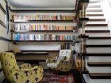 A small library where one can read and contemplate the sky through a porthole window or glazed roofhatch. The stair, built on top of the kitchen pantry leads up to the roofhatch.
© Justin Alexander

