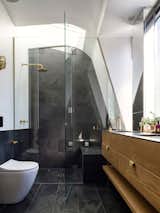 The master ensuite provides a brass shower under the stars and a toilet with a view of the clouds. The slate tiles can be used as blackboards.
© Justin Alexander

