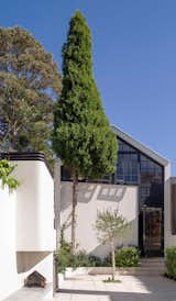 On the opposite side of the courtyard, an old garage has been rebuilt and one can still see the raked garage roof shape at the bottom of the attic studio that was added over the garage. Woollahra Council was very supportive of this project and provided an unconditional approval in record time.
© Justin Alexander