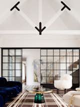 In Laura’s dreams were a fireplace, the security of steel windows, the comfort of high cathedral ceilings and the softness of the furnishings. Her nightmare was the sterile, hollow and hard edges of some ‘modern architecture’ environments. Luigi Rosselli Associate, Edward Birch, detailed the robust trusses, the raw concrete fireplace hearth and sliding steel partition that are balanced by the soft, sheer curtains, woolly rugs and furniture selected by Alexandra Donohoe, Luigi Rosselli Architect’s in house interior designer.
© Justin Alexander

