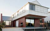 Porters Paints ‘Ox Red’ was applied to the masonry base, a memory of the hearth colour used in clay bricks. The white upper floor is pertinent to timber construction.
© Edward Birch  Photo 6 of 23 in Balancing Home by Luigi Rosselli Architects